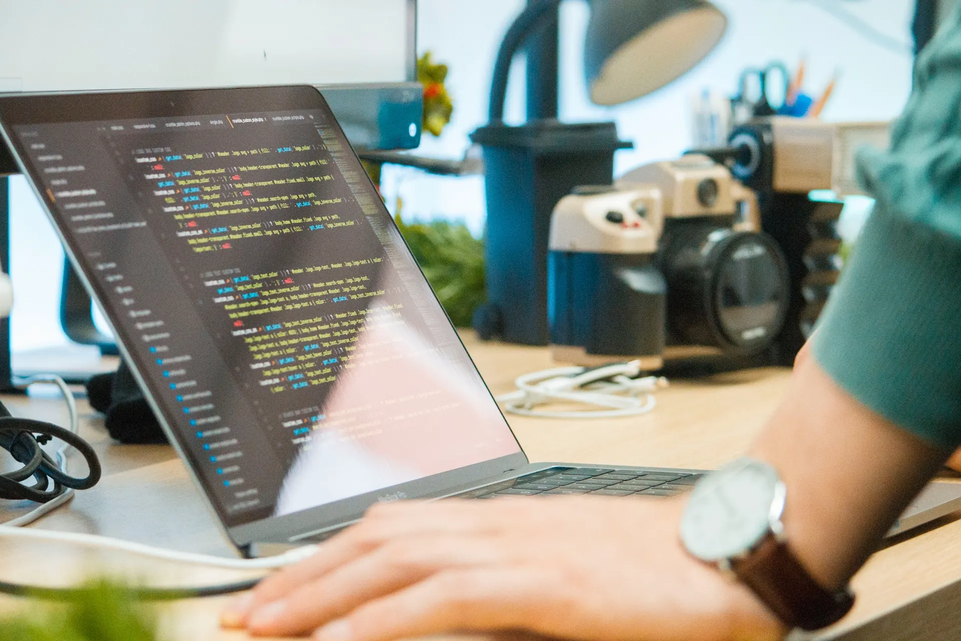 Developer writing code on a laptop